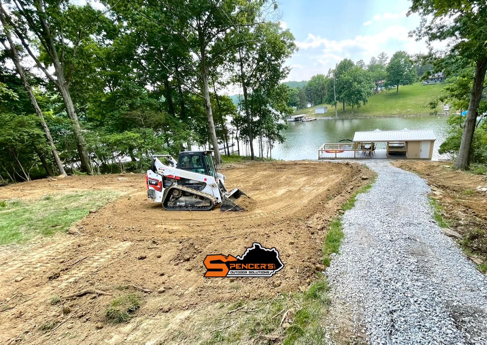 Bobcat skid steer doing excavation and grading at a lakefront property in Northern Kentucky