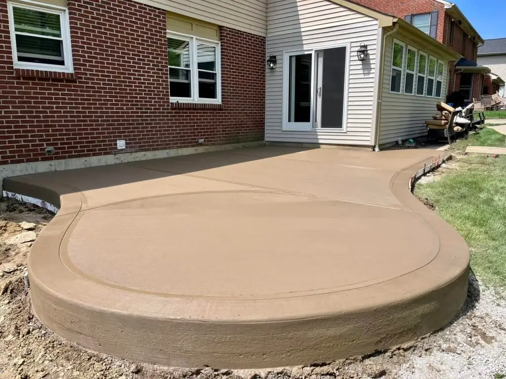 Curved broom-finish concrete patio at a residential Northern Kentucky home