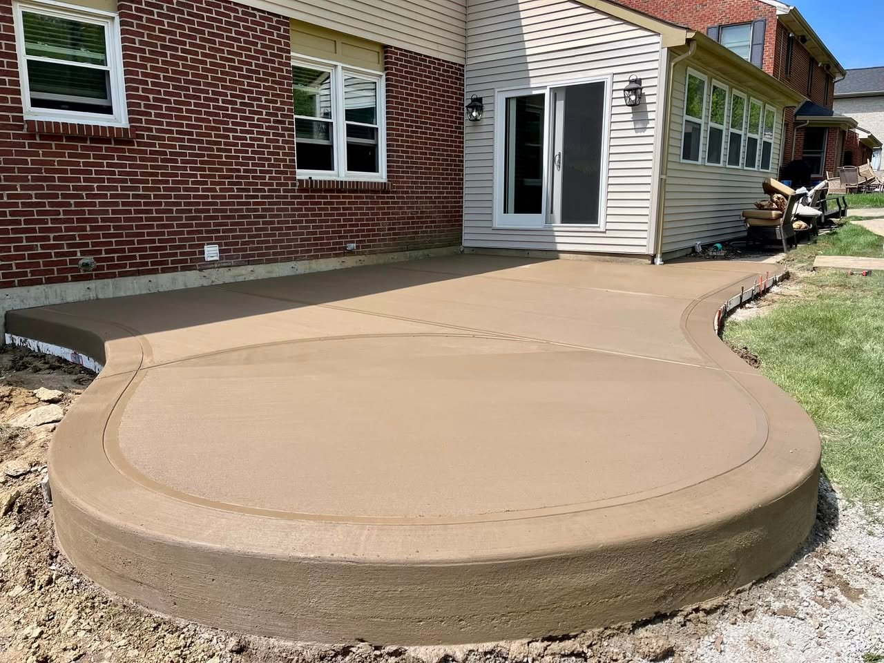 Curved broom-finish concrete patio at a residential Northern Kentucky home