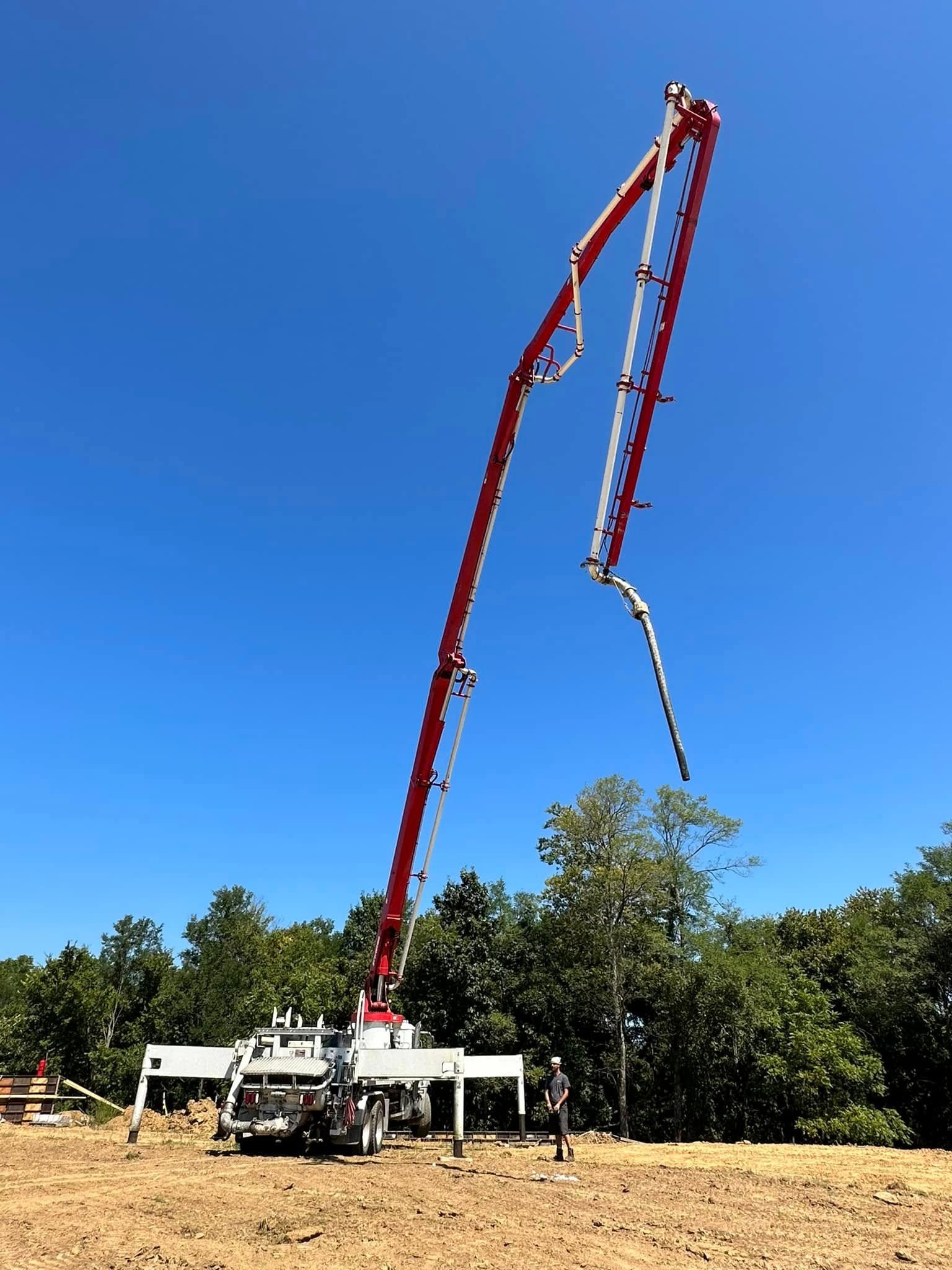 Concrete pump truck with boom vertical at a Northern Kentucky jobsite