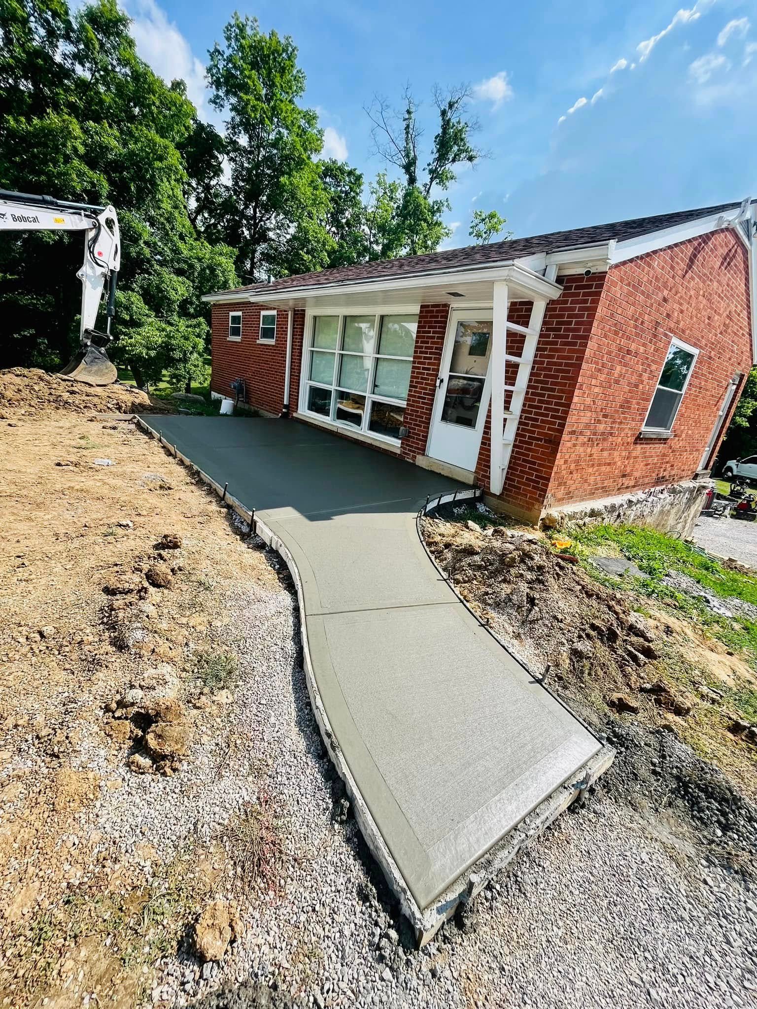 Curved concrete sidewalk and walkway fresh pour at a residential property