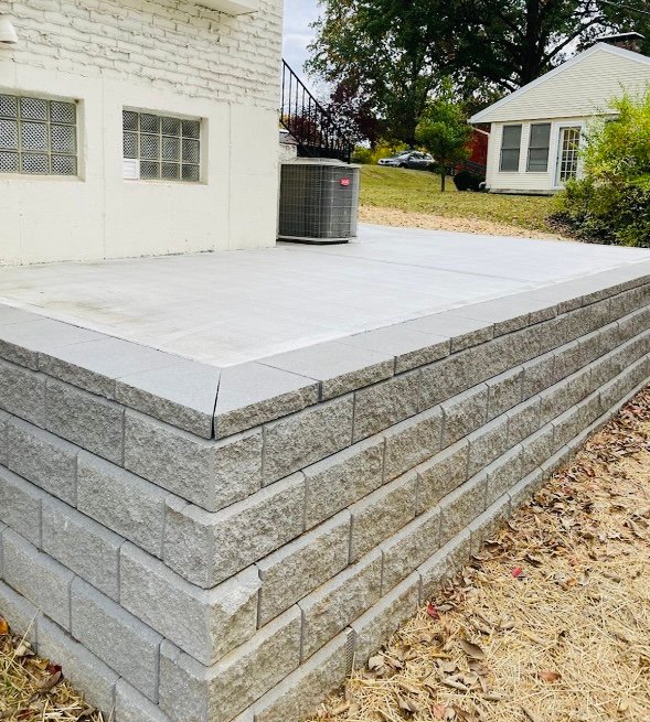 Segmental block retaining wall with raised concrete patio in Northern Kentucky