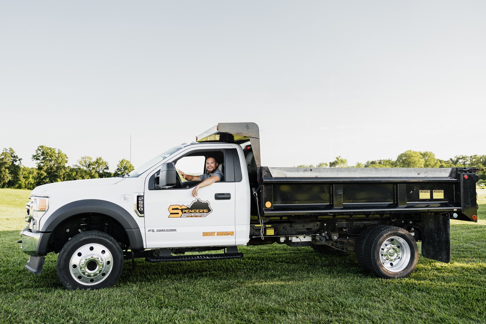 Spencer's Ford F-550 flatbed dump truck used for Northern Kentucky concrete and excavation jobs